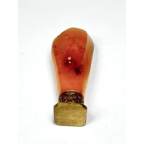 719 - A brass and amber desk seal, length 7cm, 26g