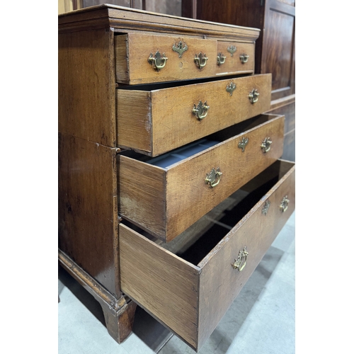 829 - An 18th-century oak chest of drawers, two short drawers over three long with brass drop handles and ... 