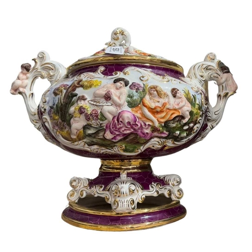 112 - A large two-handled burgundy ground Capodimonte tureen with lid, the body is decorated with gilded r... 