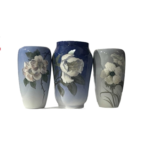 114 - Three Royal Copenhagen vases, decorated with hand painted flowers and insects on graduating blue gro... 