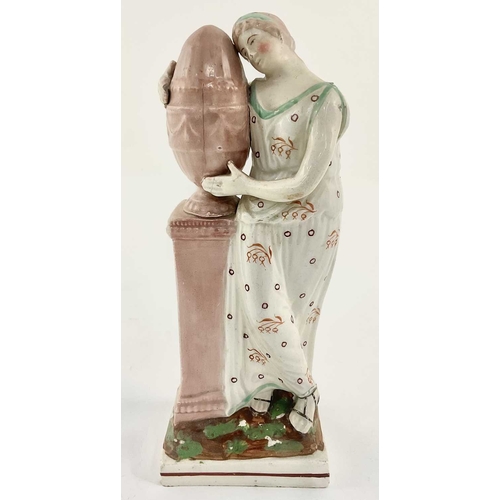 117 - A c.1800 pearlware figure on a square base modelled as Andromache standing beside a plinth on which ... 