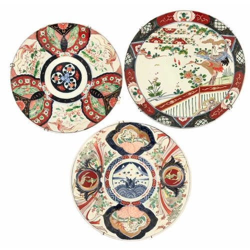 121 - Three Japanese Imari chargers, Meiji period, with hanging wires, the largest, 37cm diameter (3)