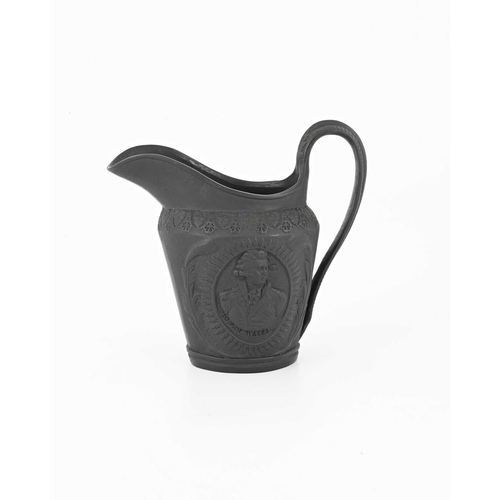 122 - A Wedgwood black basalt ware jug, circa 1790, shouldered helmet form, relief moulded portrait rounde... 