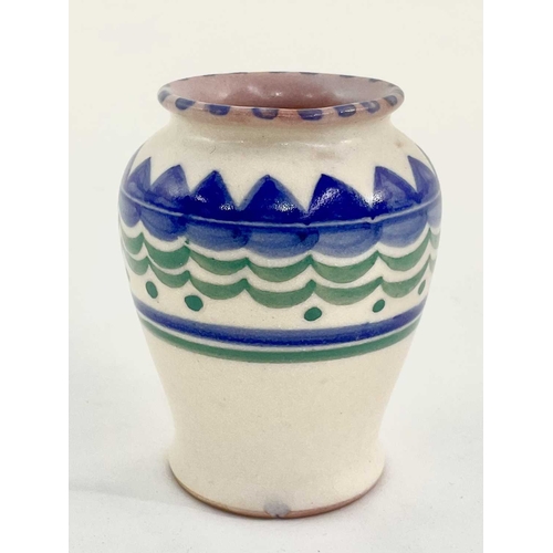 148 - A small Poole pottery vase, painted blue and green design on cream ground with Poole impressed marks... 