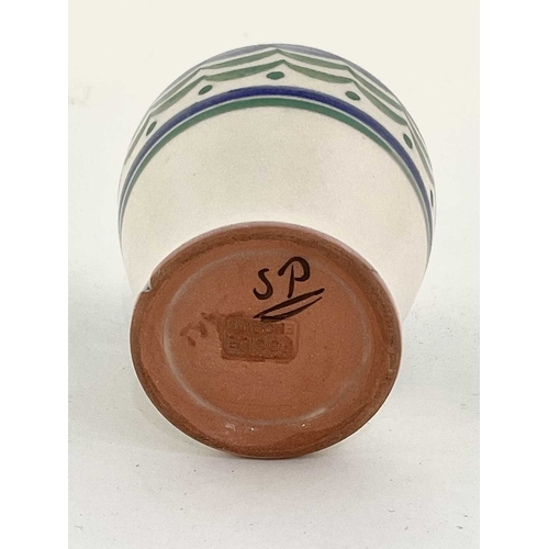 148 - A small Poole pottery vase, painted blue and green design on cream ground with Poole impressed marks... 