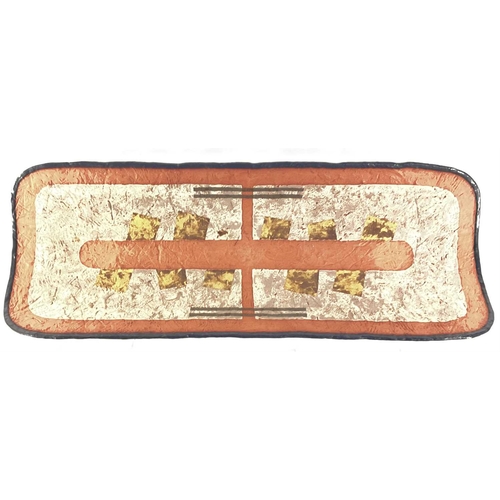 160 - An elongated terracotta wall hanging plaque or charger, signed to the reverse with the date 1993 len... 