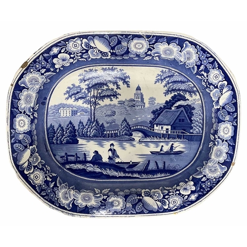 161 - A Victorian blue and white meat dish, transfer printed with a countryside river scene, the four figu... 