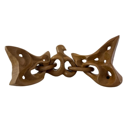 199 - A Contemporary carved wooden chain sculpture, the three abstract forms connected with two oval links... 