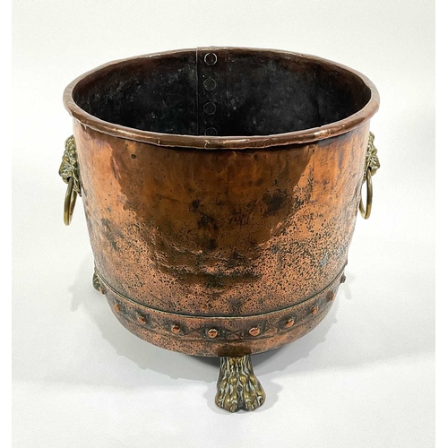 208 - A 19th century copper and brass log bin with lion mask handles to sides, riveted base and paw feet (... 