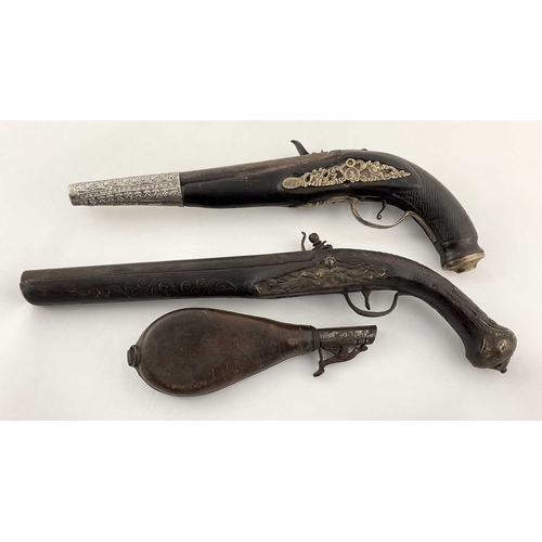 219 - Two Indian flintlock black powder dress pistols, smooth bore, one with foliate silver coloured metal... 