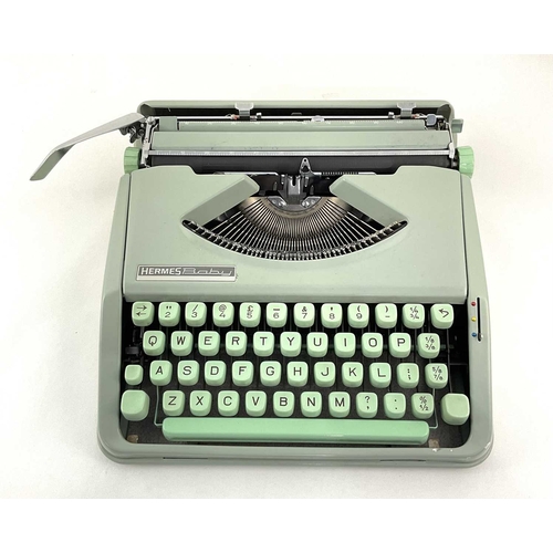 223 - A Hermes Baby typewriter in mint green with case, approx 9cm high, 30cm wide and deep (1)