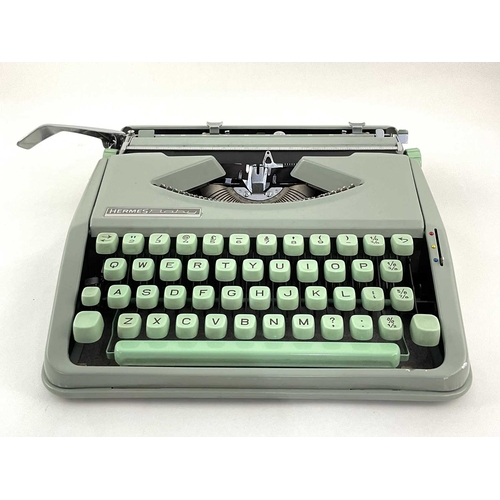 223 - A Hermes Baby typewriter in mint green with case, approx 9cm high, 30cm wide and deep (1)