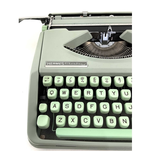 223 - A Hermes Baby typewriter in mint green with case, approx 9cm high, 30cm wide and deep (1)