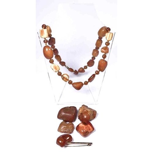 312 - A selection of amber items, to include a bead necklace, loose amber and a brooch, total weight appro... 