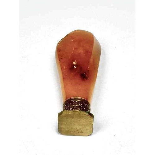 328 - A brass and amber desk seal, length 7cm, 26g