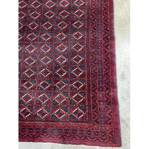 337 - A red ground Afghan Baluch-type wool rug, approx 175cm long, 122cm (1)