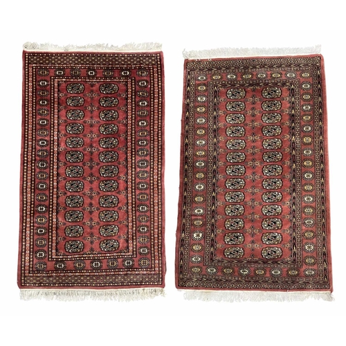 340 - Two Bokhara-type wool rugs, brown geometric design on red ground, approx 170cm long, 96cm wide (2)