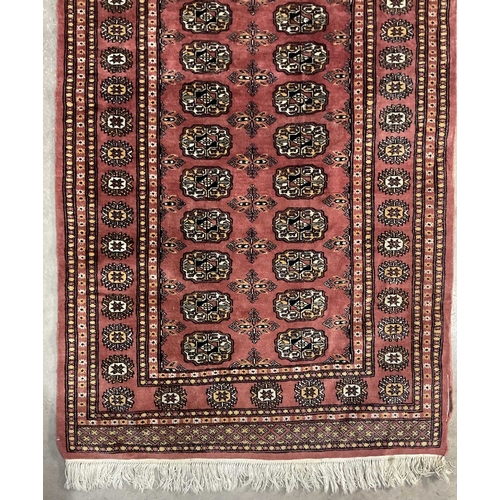 340 - Two Bokhara-type wool rugs, brown geometric design on red ground, approx 170cm long, 96cm wide (2)