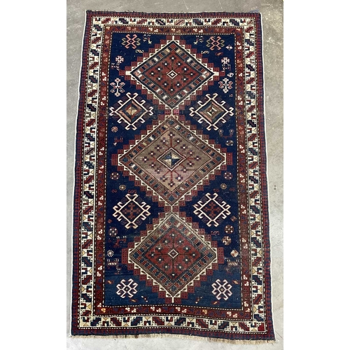 341 - A Turkish Yalameh style Navy and red wool rug with geometric pattern, approx 236cm long, 128cm wide ... 