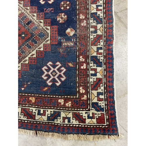 341 - A Turkish Yalameh style Navy and red wool rug with geometric pattern, approx 236cm long, 128cm wide ... 