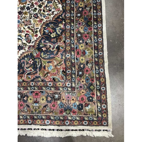 341A - A large Kashmar-type wool floral rug in a brown, cream, red and blue palette, approx 282cm long, 190... 