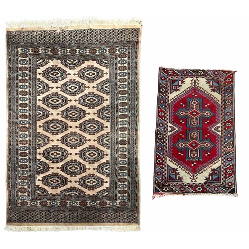 343 - Two rugs of tribal/Oriental design, one decorated with floral geometric forms on a cream ground, app... 