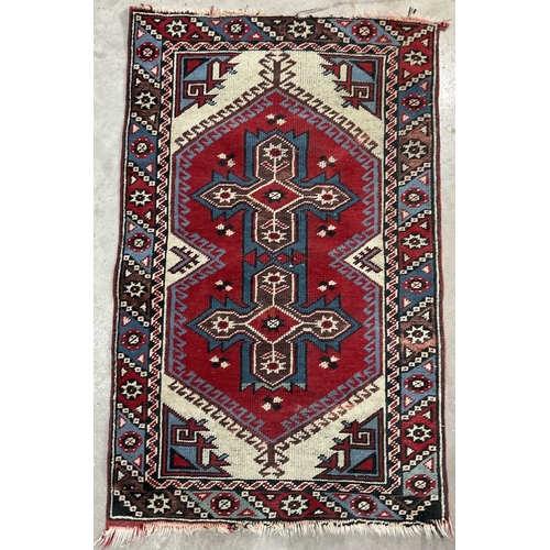 343 - Two rugs of tribal/Oriental design, one decorated with floral geometric forms on a cream ground, app... 