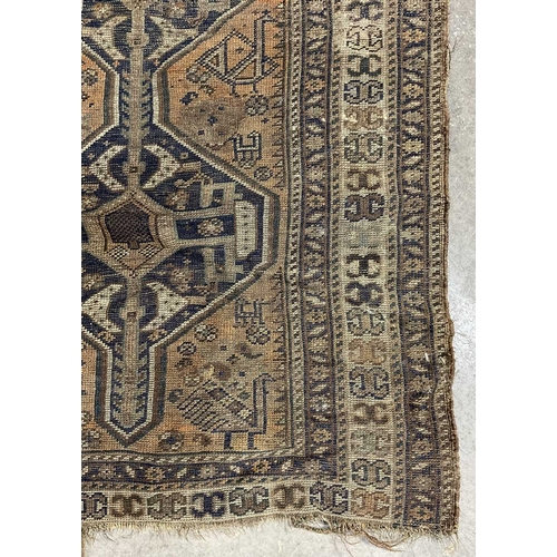 344 - A brown, orange and navy shiraz-type rug, ornamented with geometric motifs and zoomorphic animals ap... 