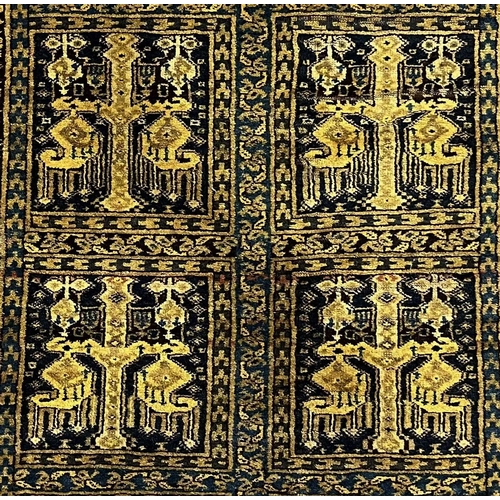 347 - An Afghan tribal rug, yellow ground, the eight square panels decorated with stylised motifs reserved... 