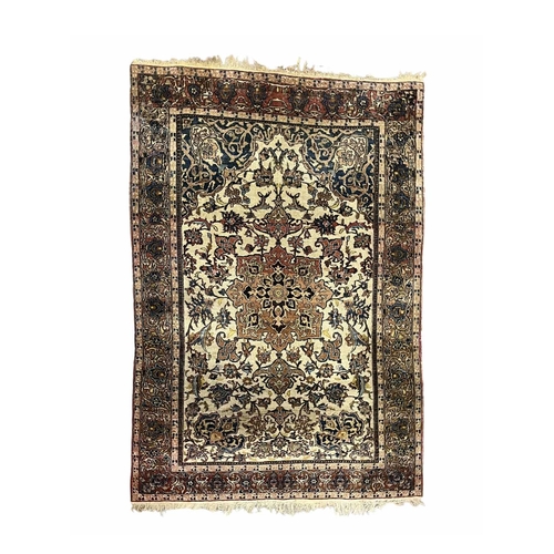 348 - A Persian Isfahan rug, the central lotus flower shaped medallion with radiating foliate tendrils, on... 