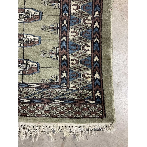 350 - A green ground wool rug with brown and blue geometric shapes, approx 160cm long, 93cm wide (1)