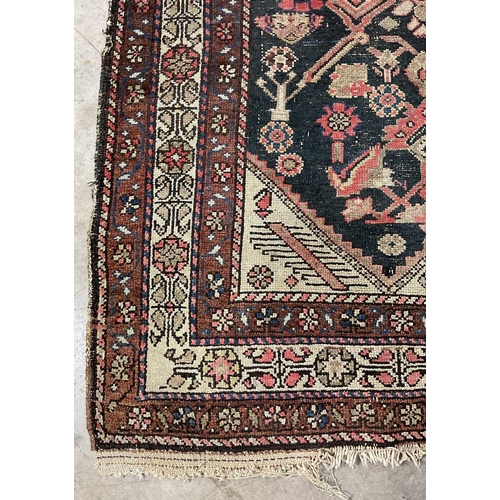 351 - A brown, red and navy runner, central rectangle section decorated with floriated forms, approx 315cm... 