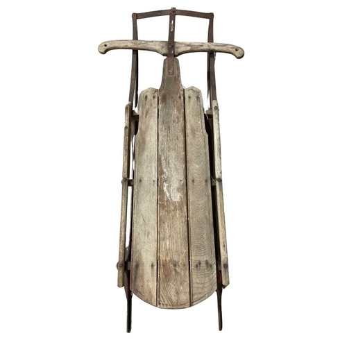 351A - Carved wood sledge or toboggan with wrought iron frame, late 19th/early 20th, 123cm long, 63cm wide ... 