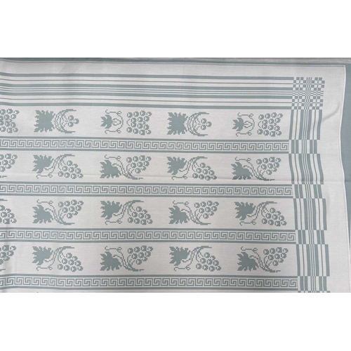 41 - A Georg Jensen linen tablecloth woven with fruiting vine motifs, teal on white ground, 150 by 200cm