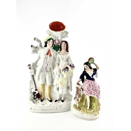 90A - A Victorian Staffordshire pottery figural spill vase, modelled as a man and woman, courting, stood b... 