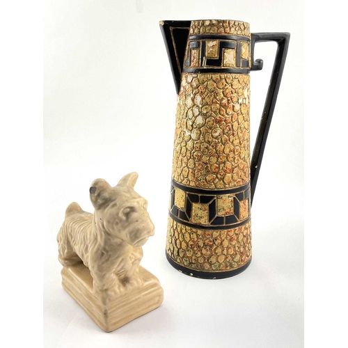 99 - An Art Deco ceramic pebble mosaic patterned jug, approx 28cm high, with a ceramic figurine of a Pric... 