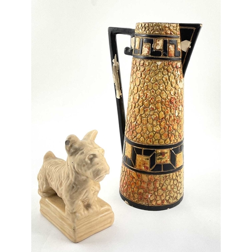 99 - An Art Deco ceramic pebble mosaic patterned jug, approx 28cm high, with a ceramic figurine of a Pric... 