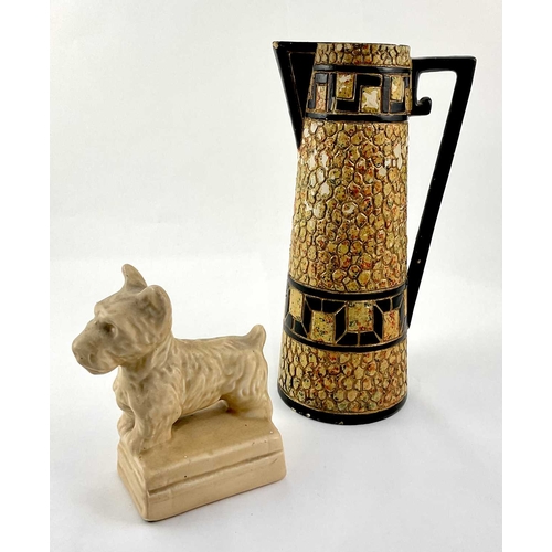 99 - An Art Deco ceramic pebble mosaic patterned jug, approx 28cm high, with a ceramic figurine of a Pric... 