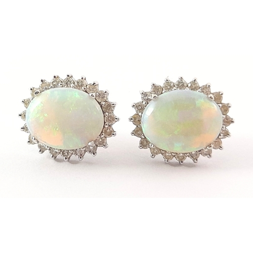 275 - A pair of 18ct gold opal and diamond cluster stud earrings