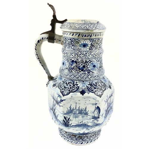 141 - A Dutch Delft tankard, 18th century style, the hexagonal panelled body painted with a continuous riv... 