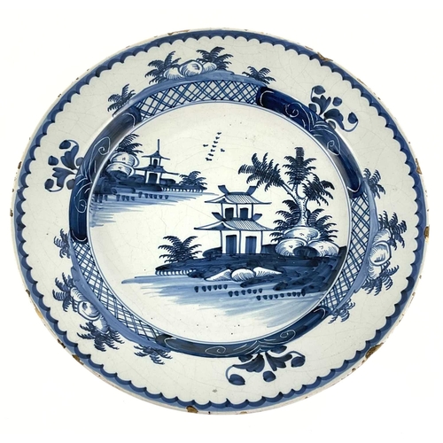 144 - An English Delftware charger, Lambeth, London, circa 1780, decorated in Chinese taste, diameter 31cm