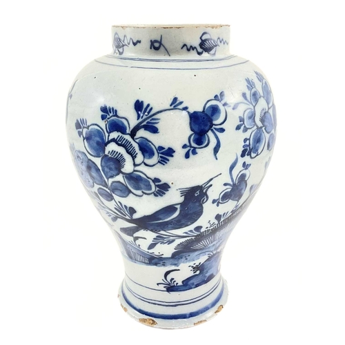 163 - A Dutch Delft baluster vase, 18th century, decorated in underglaze blue with a motif of a bird among... 