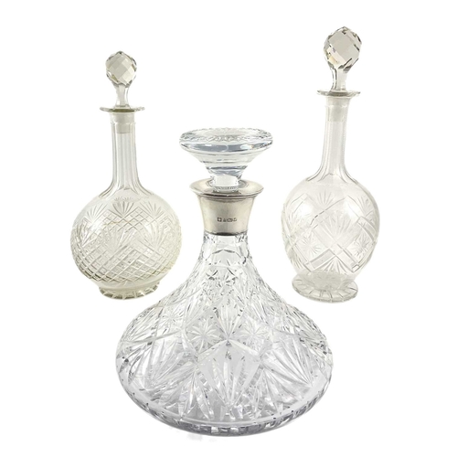 174 - A Royal Doulton cut crystal ships decanter with silver hallmarked mouth, and two globe and stem deca... 