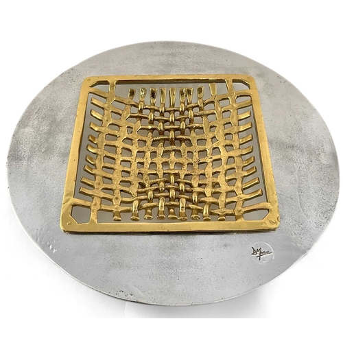 211 - A David Marshall table charger or bowl, knitted brass central square surrounded by an aluminium roun... 