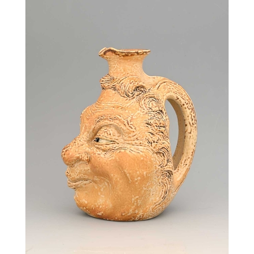 44 - Robert Wallace Matin for Matin Brothers, a stoneware characterful face jug, 1901, modelled in relief... 