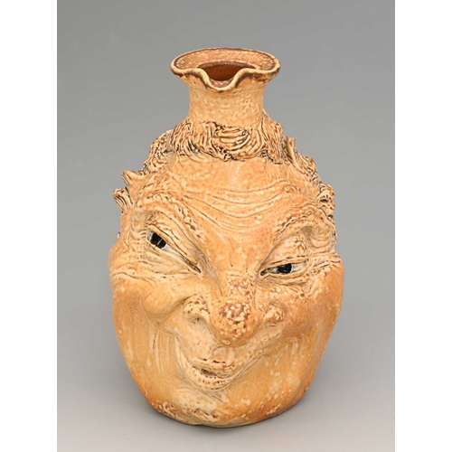 44 - Robert Wallace Matin for Matin Brothers, a stoneware characterful face jug, 1901, modelled in relief... 