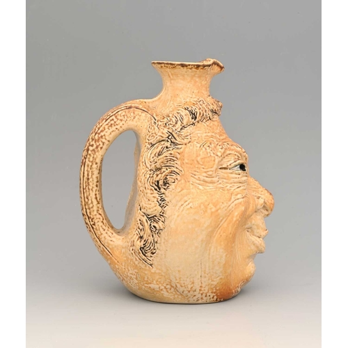 44 - Robert Wallace Matin for Matin Brothers, a stoneware characterful face jug, 1901, modelled in relief... 