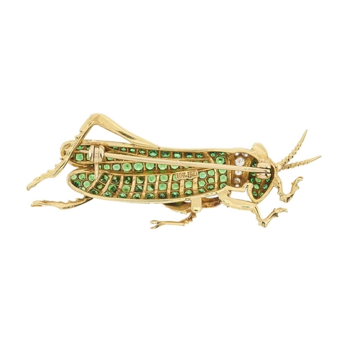 104 - Eli Frei, an 18ct gold green garnet and brilliant-cut diamond grasshopper brooch, with ruby cabochon... 