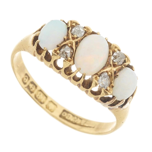 131 - An Edwardian 18ct gold opal cabochon three-stone dress ring, with old-cut diamond double spacers, ha... 