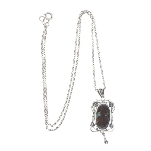 135 - An Art Nouveau silver boulder opal cabochon pendant, with foliate surround and bead accent drop, sus... 